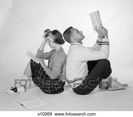 1950S Couple Teen Boy Girl Sitting Back To Back Reading Books Studying View Large Photo Image Stock Photo - 1950S Couple Teen Boy Girl Sitting Back To Back Reading Books Studying . Fotosearch