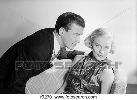 1950S Couple With The Woman Sitting Looking Away Man Profile Looking Blonde Hair Well Dressed Satin View Large Photo Image Stock Image - 1950S Couple With The Woman Sitting Looking Away Man Profile Looking Blonde Hair Well Dressed Satin. Fotosearch