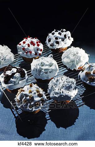 1950S Cupcakes White Icing Decorations Chips Jimmies Nuts On Metal Cooling Rack View Large Photo Image Stock Photo - 1950S Cupcakes White Icing Decorations Chips Jimmies Nuts On Metal Cooling Rack . Fotosearch