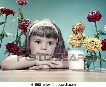 1950S Cute Thoughtful Girl Bangs White Headband Leaning Arms & Head On Table Glass Of Milk Flowers Zinnias Behind View Large Photo Image Stock Photo - 1950S Cute Thoughtful Girl Bangs White Headband Leaning Arms & Head On Table Glass Of Milk Flowers Zinnias Behind. Fotosearch