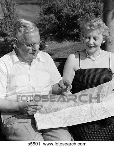 1950S Elderly Couple Seated On Bench Looking At Map View Large Photo Image Stock Image - 1950S Elderly Couple Seated On Bench Looking At Map . Fotosearch