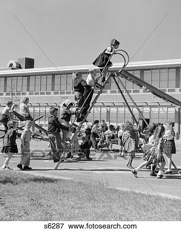 1950S Elementary School Playground At Recess With Line Of Children Climbing Ladder Of Slide View Large Photo Image Stock Photo - 1950S Elementary School Playground At Recess With Line Of Children Climbing Ladder Of Slide . Fotosearch