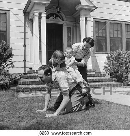 1950S Family Front Lawn House Two Kids Riding Father Piggyback Mother Helping Toddler Baby View Large Photo Image Stock Image - 1950S Family Front Lawn House Two Kids Riding Father Piggyback Mother Helping Toddler Baby . Fotosearch