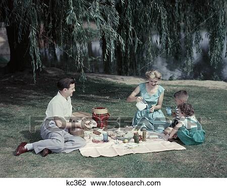 1950S Family Mother Father Boy Girl 4 Picnic Under Weeping Willow Tree By Lake Pond Plaid Thermos Milk Summer Meal Food View Large Photo Image Stock Image - 1950S Family Mother Father Boy Girl 4 Picnic Under Weeping Willow Tree By Lake Pond Plaid Thermos Milk Summer Meal Food. Fotosearch