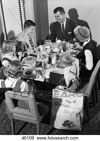 1950S Family Of 5 Eat In Restaurant Meal Table Full Of Food Bounty Shopping Bag Gimbels Mom Dad Kids 2 Boys 2 Girls View Large Photo Image Stock Photo - 1950S Family Of 5 Eat In Restaurant Meal Table Full Of Food Bounty Shopping Bag Gimbels Mom Dad Kids 2 Boys 2 Girls . Fotosearch