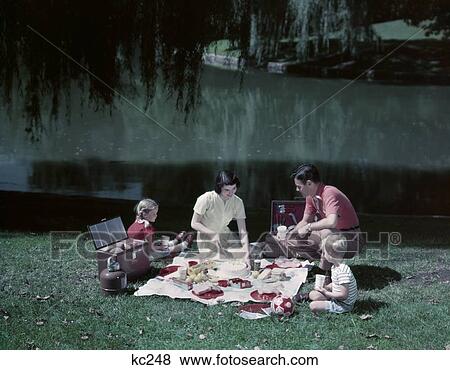 1950S Family Picnic By Pond Lake Mom Dad Boy Girl Willow Tree Tablecloth Spread Cooler Thermos Basket Food Summer Meal View Large Photo Image Stock Photo - 1950S Family Picnic By Pond Lake Mom Dad Boy Girl Willow Tree Tablecloth Spread Cooler Thermos Basket Food Summer Meal. Fotosearch