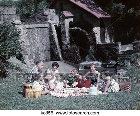 1950S Family Summer Picnic Grass Water Mill Mother Father Man Woman Children Boys Girls View Large Photo Image Stock Photograph - 1950S Family Summer Picnic Grass Water Mill Mother Father Man Woman Children Boys Girls. Fotosearch
