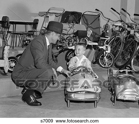 Stock Photo - 1950S Father In Toy Store With Son Driving Toy Convertible . Fotosearch