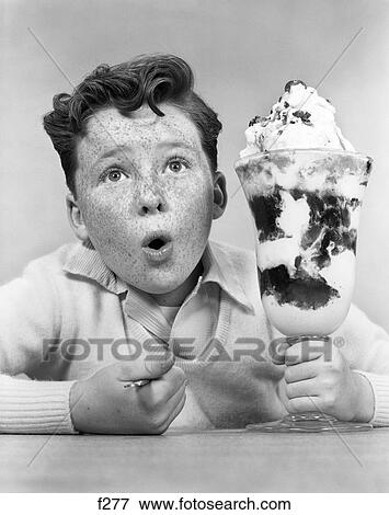 1950S Freckle Faced Boy With Funny Expression Looking At Giant Sized Ice Cream Sundae Parfait View Large Photo Image Stock Photo - 1950S Freckle Faced Boy With Funny Expression Looking At Giant Sized Ice Cream Sundae Parfait . Fotosearch