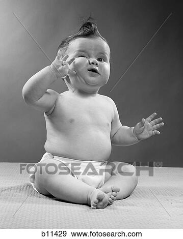 1950S Full Figure Baby Sitting Gesture Hand Touching Cheek Face Expression Funny View Large Photo Image Stock Photo - 1950S Full Figure Baby Sitting Gesture Hand Touching Cheek Face Expression Funny . Fotosearch