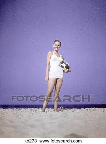 1950S Full Length Portrait Woman White Bathing Suit Swimwear Standing On Sand Holding Beach Ball Fashion View Large Photo Image Stock Image - 1950S Full Length Portrait Woman White Bathing Suit Swimwear Standing On Sand Holding Beach Ball Fashion. Fotosearch