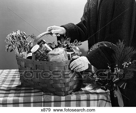 1950S Gift Basket Filled With Preserves Vegetables Bread Food Held By Figure With Gloved Hands On Checkerboard Tablecloth View Large Photo Image Stock Photo - 1950S Gift Basket Filled With Preserves Vegetables Bread Food Held By Figure With Gloved Hands On Checkerboard Tablecloth. Fotosearch