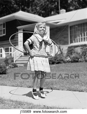 Stock Photo - 1950S Girl In Dress On Suburban Sidewalk Using The Hula Hoop . Fotosearch
