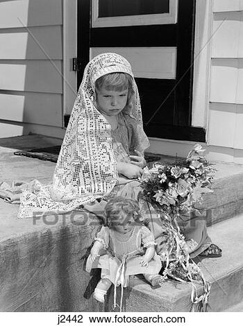 Stock Image - 1950S Girl In Mock Bride Costume With Bouquet In Lap & Baby Doll At Feet With Sad Look On Face . Fotosearch