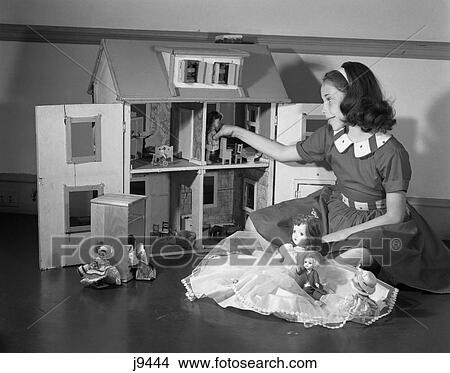 1950S Girl Playing With Doll House & Dolls Toys View Large Photo Image Picture - 1950S Girl Playing With Doll House & Dolls Toys . Fotosearch