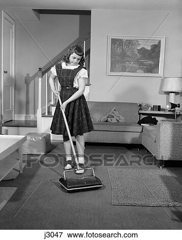 1950S Girl Using Non Electric Vacuum Clean Carpet Living Room Chore Fashion Sweeper Wearing Jumper View Large Photo Image Stock Photo - 1950S Girl Using Non Electric Vacuum Clean Carpet Living Room Chore Fashion Sweeper Wearing Jumper . Fotosearch