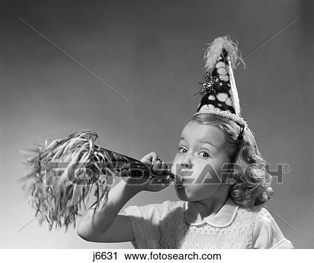 Stock Image - 1950S Girl Wearing Party Hat Blowing Into Noise Maker . Fotosearch