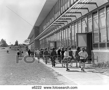 1950S Grade School Children Filing Out Of Side Doors Of School & Walking Length Of Building View Large Photo Image Stock Image - 1950S Grade School Children Filing Out Of Side Doors Of School & Walking Length Of Building . Fotosearch