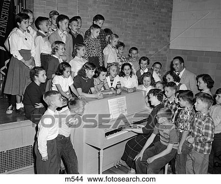 1950S Group School Kids Boys Girls Piano Singing Teacher Plays Choir Chorus Rehearsal Practice Sing Penn Valley School View Large Photo Image Picture - 1950S Group School Kids Boys Girls Piano Singing Teacher Plays Choir Chorus Rehearsal Practice Sing Penn Valley School . Fotosearch