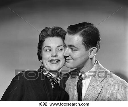 Stock Image - 1950S Head To Head Portrait Smiling Couple Flirting Man Woman Retro . Fotosearch