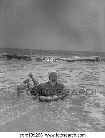 1950S Laughing Woman On Inflated Raft In Surf View Large Photo Image Stock Image - 1950S Laughing Woman On Inflated Raft In Surf. Fotosearch