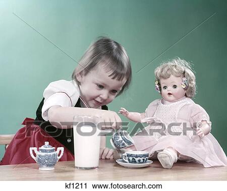 1950S Little Girl Toddler And Baby Doll Having Tea Party Blue Willow Cup Saucer And Big Glass Of Milk Table Red Skirt View Large Photo Image Stock Image - 1950S Little Girl Toddler And Baby Doll Having Tea Party Blue Willow Cup Saucer And Big Glass Of Milk Table Red Skirt. Fotosearch