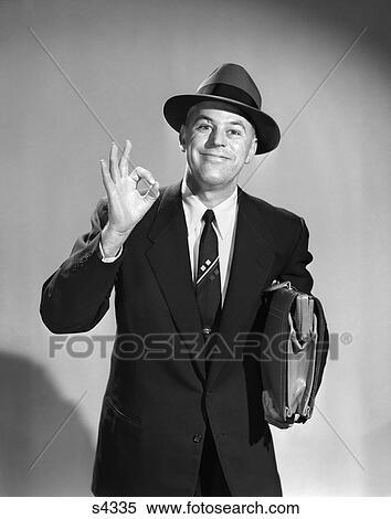 Stock Photography - 1950S Man Businessman Salesman Making Okay Sign With One Hand Carrying Briefcase Wearing Hat . Fotosearch