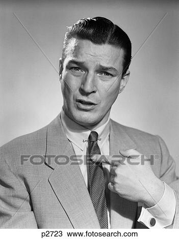 1950S Man Businessman Serious Expression Pointing To His Chest Confused Questioning Who Me View Large Photo Image Stock Image - 1950S Man Businessman Serious Expression Pointing To His Chest Confused Questioning Who Me . Fotosearch