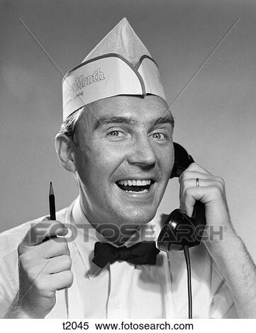 1950S Man Food Service Uniform Hat Talking On Telephone Holding Pencil Smiling Grocer Baker Waiter View Large Photo Image Stock Photography - 1950S Man Food Service Uniform Hat Talking On Telephone Holding Pencil Smiling Grocer Baker Waiter . Fotosearch