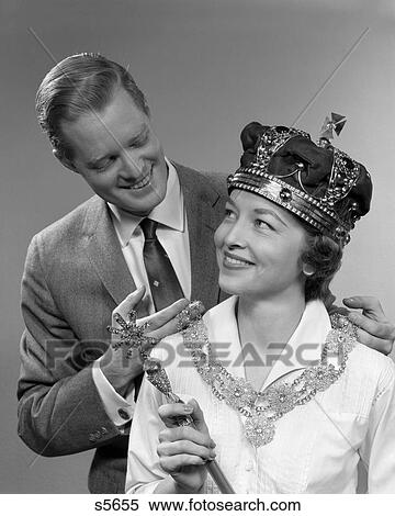 1950S Man Holding Necklace On Woman Wearing Crown And Holding Scepter View Large Photo Image Stock Photography - 1950S Man Holding Necklace On Woman Wearing Crown And Holding Scepter . Fotosearch