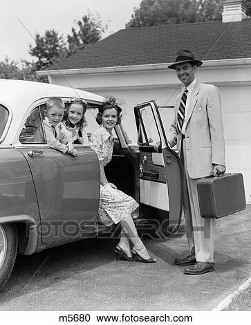 1950S Man Holding Suitcase And Opening Car Door With Mother & Children Inside View Large Photo Image Stock Image - 1950S Man Holding Suitcase And Opening Car Door With Mother & Children Inside . Fotosearch