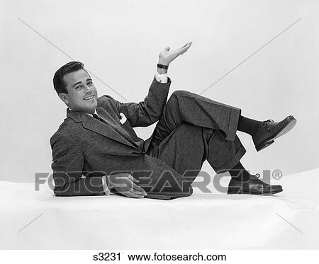 1950S Man In Suit & Tie On Floor Leaning Back On Elbow With Legs Crossed & Hand In Air View Large Photo Image Stock Image - 1950S Man In Suit & Tie On Floor Leaning Back On Elbow With Legs Crossed & Hand In Air . Fotosearch