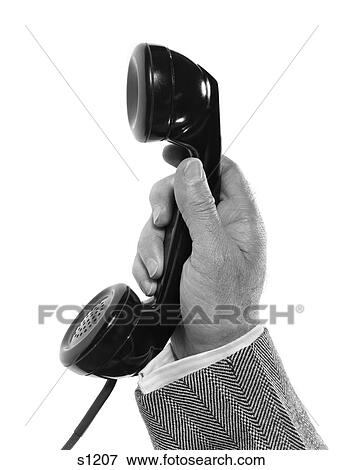 Stock Photo - 1950S Man'S Hand Holding Telehpone Receiver With Herringbone Jacket Sleeve Showing . Fotosearch