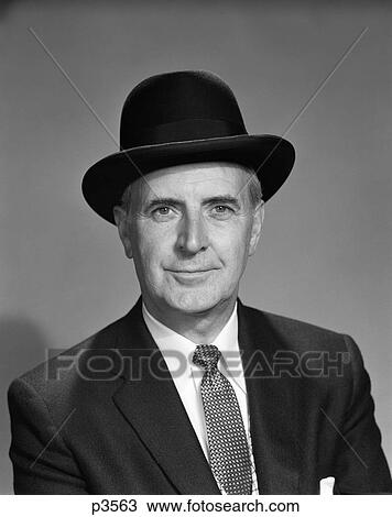 1950S Middle-Aged Senior Businessman Man Wearing Black Hat Upscale Successful Smiling View Large Photo Image Stock Image - 1950S Middle-Aged Senior Businessman Man Wearing Black Hat Upscale Successful Smiling . Fotosearch