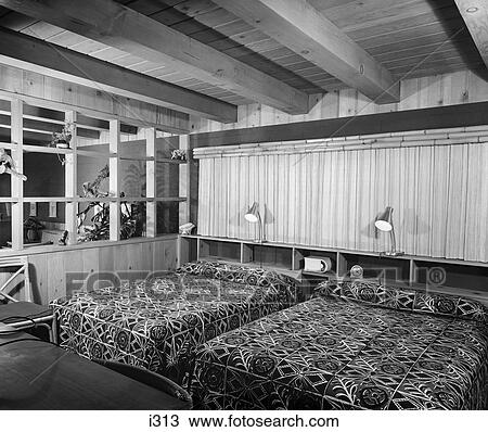 Stock Image - 1950S Motel Room With 2 Double Beds Wood Paneling & Windows To Look Through To Living Area . Fotosearch