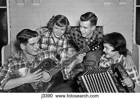 1950S Music Quartet Band Two Couples Teen Boys Girls Singing Playing Guitar & Accordion Wearing Plaid Shirts View Large Photo Image Stock Image - 1950S Music Quartet Band Two Couples Teen Boys Girls Singing Playing Guitar & Accordion Wearing Plaid Shirts . Fotosearch