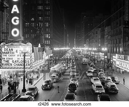 1950S Night Scene Of Chicago'S State Street With Traffic And Movie Marquee With Pedestrians On The Sidewalks View Large Photo Image Stock Photograph - 1950S Night Scene Of Chicago'S State Street With Traffic And Movie Marquee With Pedestrians On The Sidewalks . Fotosearch