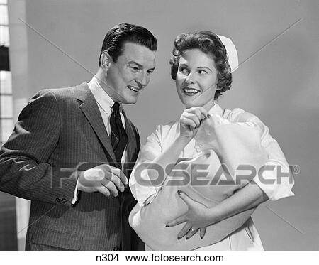1950S Nurse Showing Newborn Baby Infant To New Father View Large Photo Image Picture - 1950S Nurse Showing Newborn Baby Infant To New Father . Fotosearch