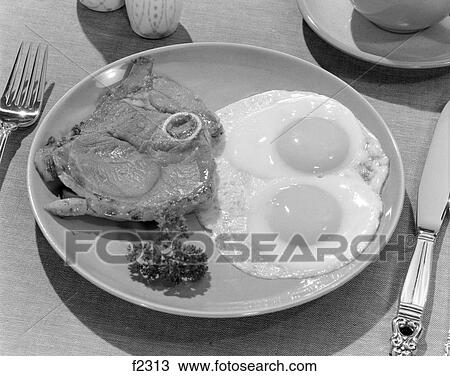 1950S Plate Of Steak & 2 Fried Eggs With Parsley Garnish & Silverware At Side View Large Photo Image Stock Image - 1950S Plate Of Steak & 2 Fried Eggs With Parsley Garnish & Silverware At Side . Fotosearch