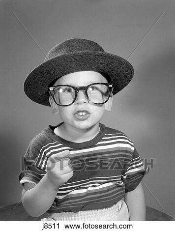 1950S Portrait Boy Dressing Up In Adult Business Man'S Hat And Glasses Wearing Striped Tee Shirt View Large Photo Image Stock Image - 1950S Portrait Boy Dressing Up In Adult Business Man'S Hat And Glasses Wearing Striped Tee Shirt . Fotosearch