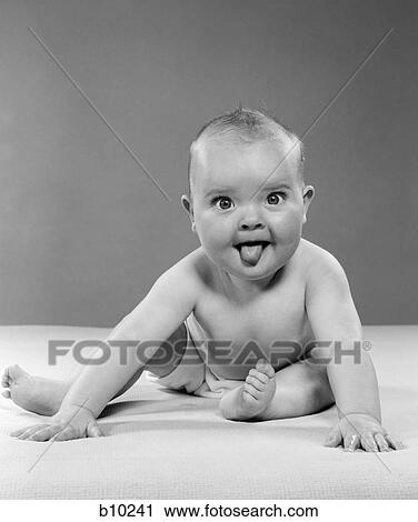 1950S Portrait Of Baby Sitting And Sticking Tongue Out Indoor View Large Photo Image Stock Image - 1950S Portrait Of Baby Sitting And Sticking Tongue Out Indoor . Fotosearch