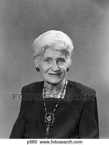 Stock Image - 1950S Portrait Of Elderly White Haired Woman With Square Necked Black Dress And Antique Jewelry . Fotosearch