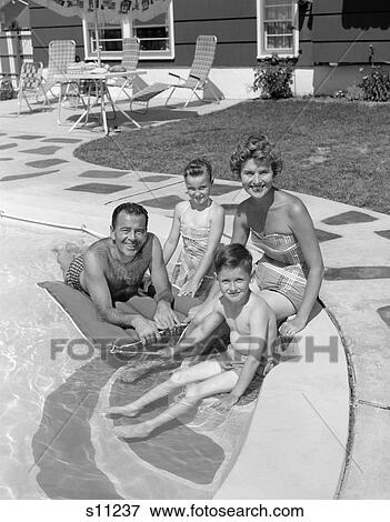 1950S Portrait Of Family Of Four Sitting Poolside Smiling View Large Photo Image Stock Photo - 1950S Portrait Of Family Of Four Sitting Poolside Smiling . Fotosearch