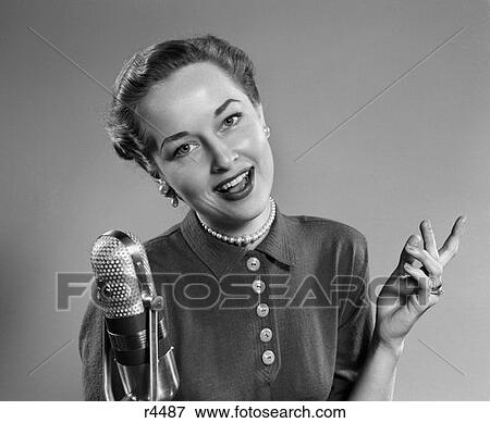 1950S Portrait Of Woman Singing Or Speaking At Microphone Radio Broadcast Indoor View Large Photo Image Stock Photo - 1950S Portrait Of Woman Singing Or Speaking At Microphone Radio Broadcast Indoor . Fotosearch