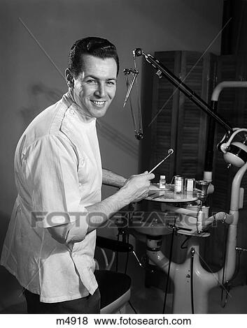 1950S Portrait Smiling Dentist Man Professional Holding Dental Tool By Drill View Large Photo Image Stock Photo - 1950S Portrait Smiling Dentist Man Professional Holding Dental Tool By Drill . Fotosearch