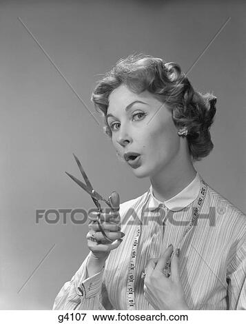 1950S Portrait Woman Holding Scissors And Measuring Tape View Large Photo Image Stock Photo - 1950S Portrait Woman Holding Scissors And Measuring Tape . Fotosearch