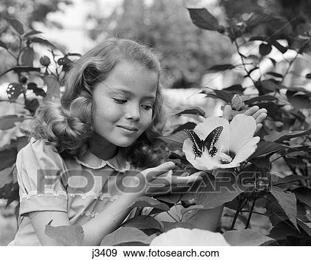 1950S Pretty Little Girl Smiling At Hibiscus Flower & Butterfly In Garden View Large Photo Image Stock Photo - 1950S Pretty Little Girl Smiling At Hibiscus Flower & Butterfly In Garden . Fotosearch