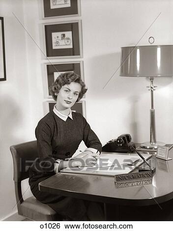 1950S Receptionist Seated At Desk With Note Pad & Pencil Behind Information Sign View Large Photo Image Stock Photograph - 1950S Receptionist Seated At Desk With Note Pad & Pencil Behind Information Sign . Fotosearch