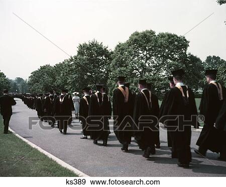 1950S Row Of Graduates From Rear Gold Hoods Procession College Graduation Outdoors Walking Down Campus Road View Large Photo Image Stock Photo - 1950S Row Of Graduates From Rear Gold Hoods Procession College Graduation Outdoors Walking Down Campus Road. Fotosearch