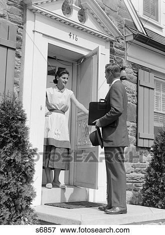 1950S Salesman At Door Talking To Housewife Stock Photo s6 photo